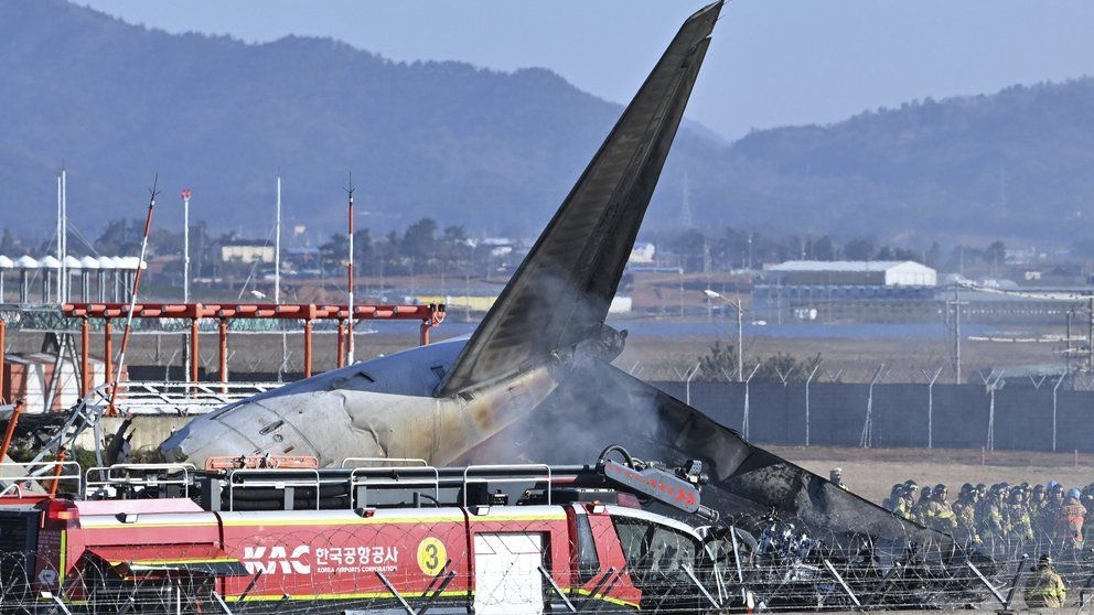 Firefighters and rescue team members work on the runway of Muan International Airport in Muan, South Korea, Sunday, Dec. 29, 2024. (Lee Young-ju/Newsis via AP)