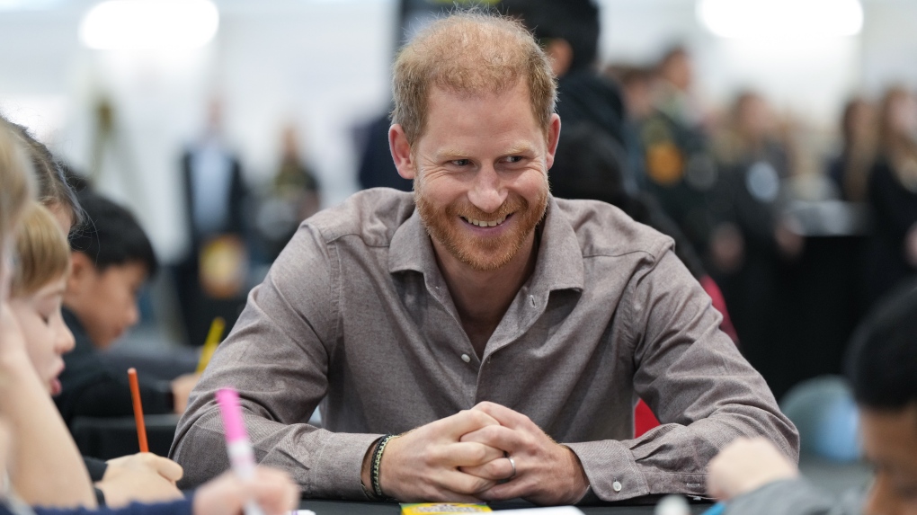 Prince Harry, the Duke of Sussex, talks with students from Shaughnessy Elementary School during an event to launch the Invictus Games school program, in Vancouver, on Monday, November 18, 2024. (Darryl Dyck / The Canadian Press)