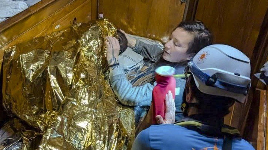 Rescuers attend to an 11-year-old girl from Sierra Leone who was found floating in the Mediterranean Sea off Italy's southernmost Lampedusa island. (AP Photo/CompassCollective, HO)