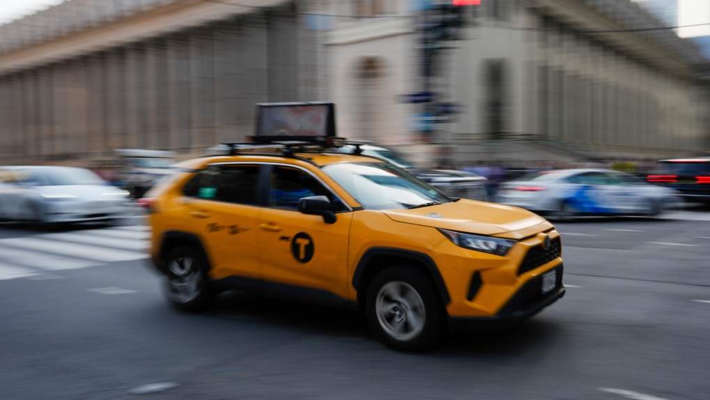 A taxi moves along eighth Avenue Wednesday, May 8, 2024, in New York. (AP Photo/Frank Franklin II)