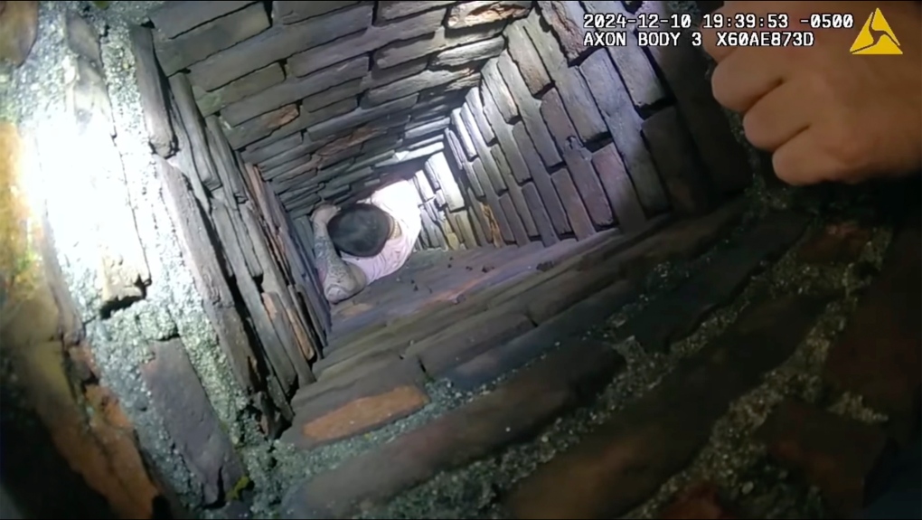 This image provided by City of Fall River Police Department shows police encounter of a man attempting to evade arrest by hiding inside a chimney on Tuesday, Dec. 10, 2024 in Fall River, Mass. (City of Fall River Police Department via AP)
