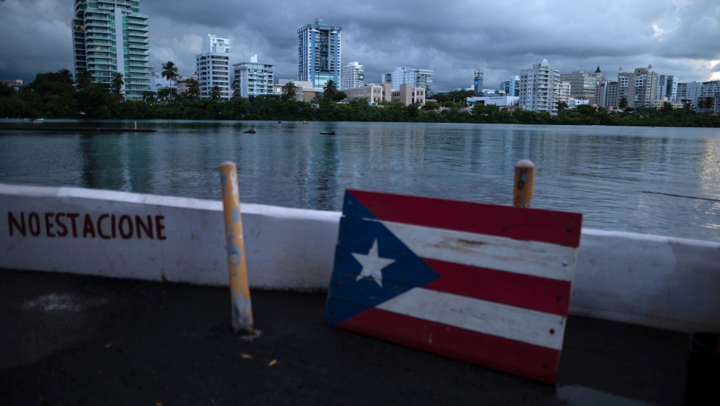 A wooden Puerto Rican flag is displayed on the dock of the Condado lagoon, in San Juan, Puerto Rico, Sept. 30, 2021. (AP Photo/Carlos Giusti)