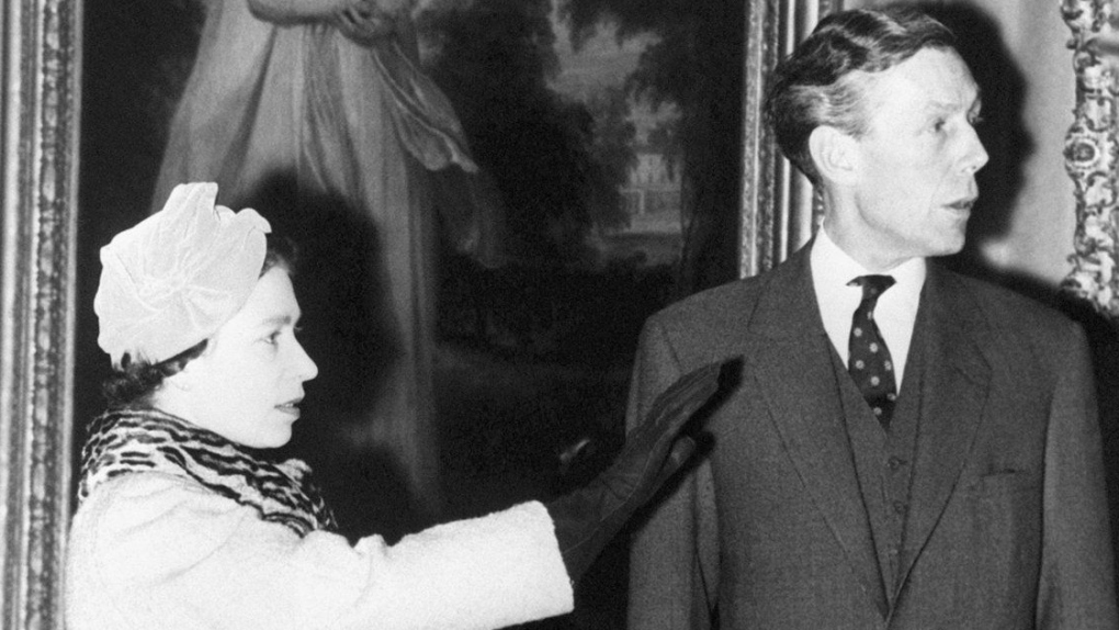 Professor Anthony Blunt, former surveyor of the Queen's pictures, photographed at the Courtauld Institute with Queen Elizabeth II on Nov. 15, 1979. (PA via AP, File)